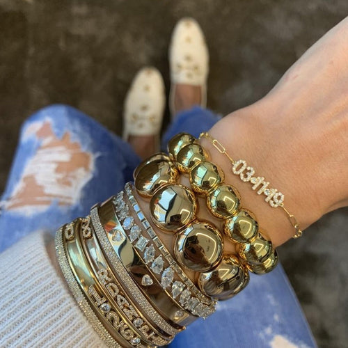 Aura Dama Bracelet  on model- Large bead left and small bead to the right .