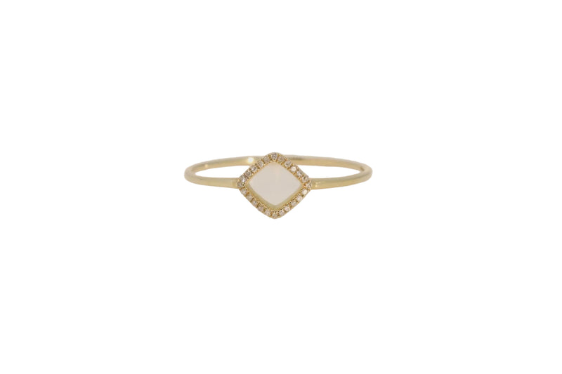 A delicate gold ring featuring a small diamond-shaped pavé setting with tiny clear stones, photographed on a plain light beige background.