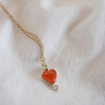 The front is a heart-shaped Carnelian stone, with a small diamond bezel.