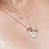 Model wearing a complement of ZAHAVA Pendant necklaces including the Pink Tourmaline /Diamond Heart Reversible Charm