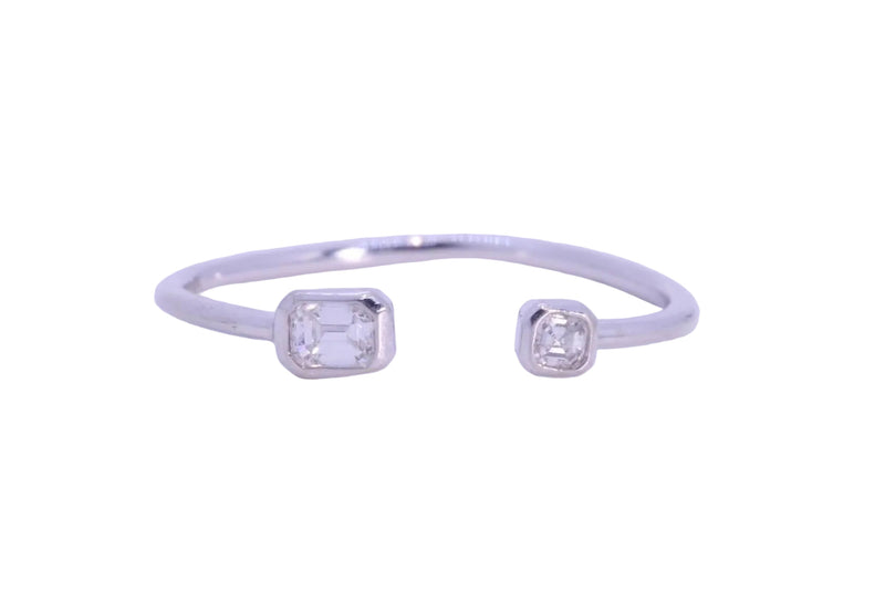 A white gold open cuff ring featuring two square-cut Diamonfs in bezel settings, shown on a plain white background.
